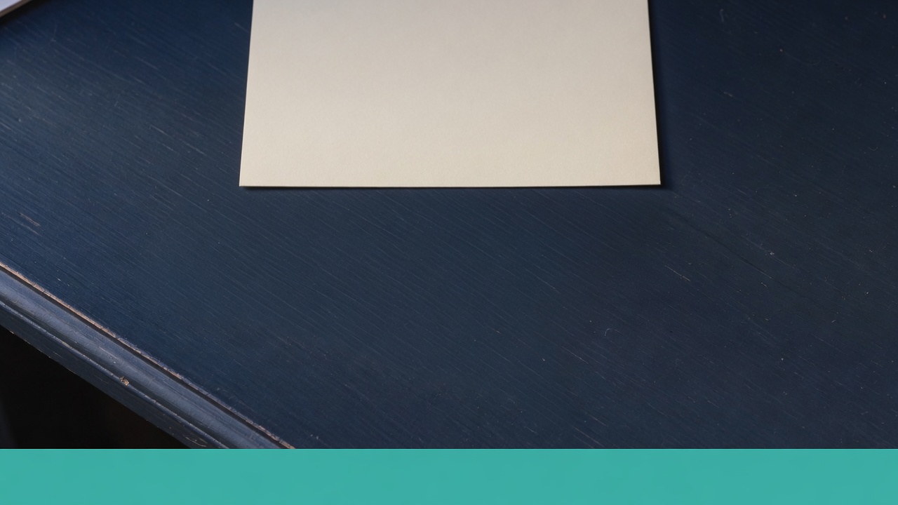 Cream stationery and a teal accent on a dark navy desk