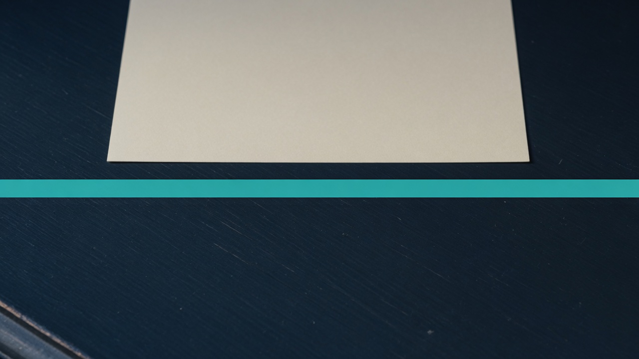 Cream stationery and a teal accent on a dark navy desk