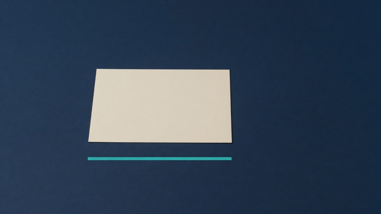 Cream stationery and a teal accent on a dark navy desk
