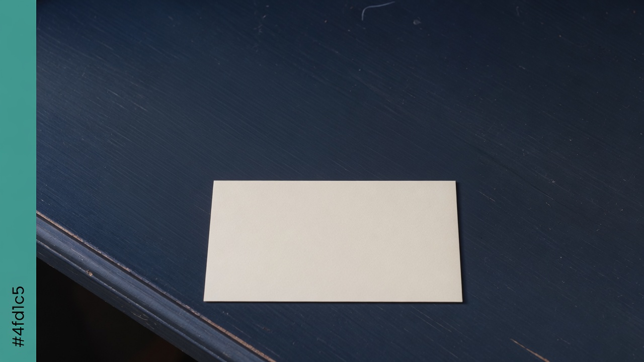 Cream stationery and a teal accent on a dark navy desk