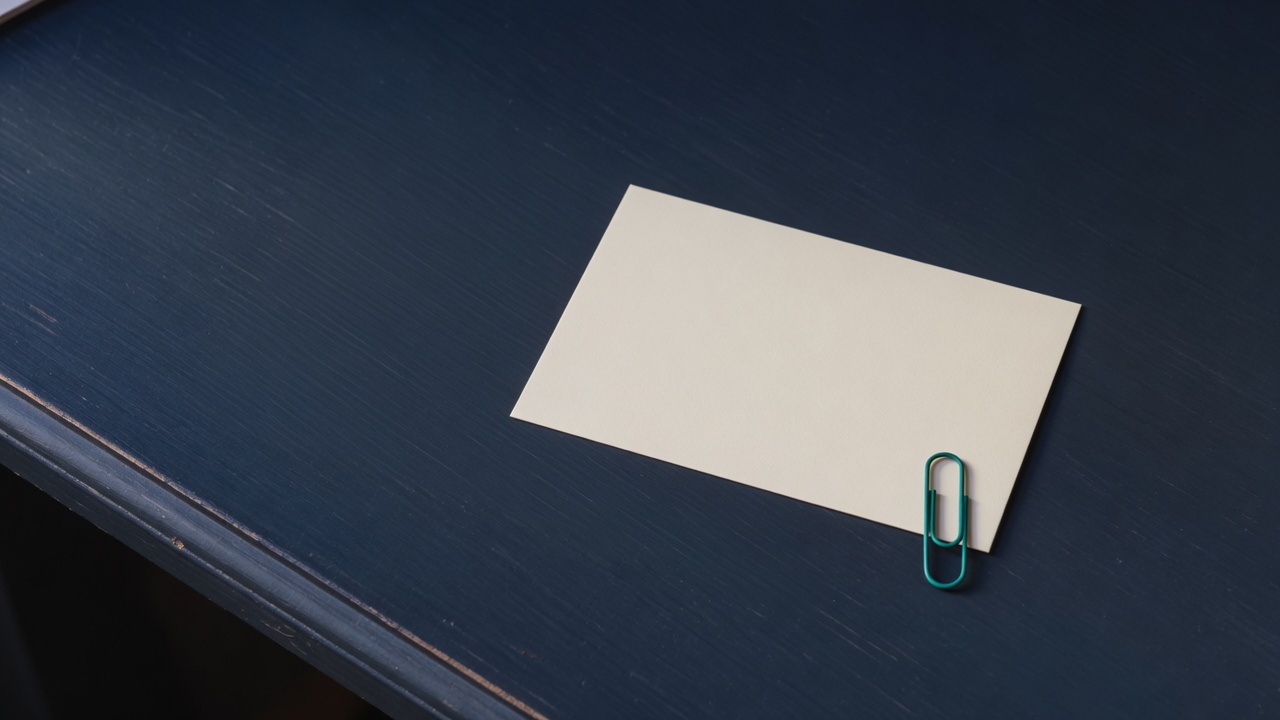 Cream stationery and a teal accent on a dark navy desk
