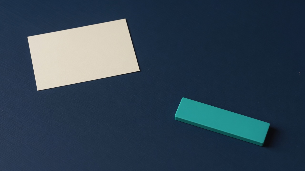 Cream stationery and a teal accent on a dark navy desk