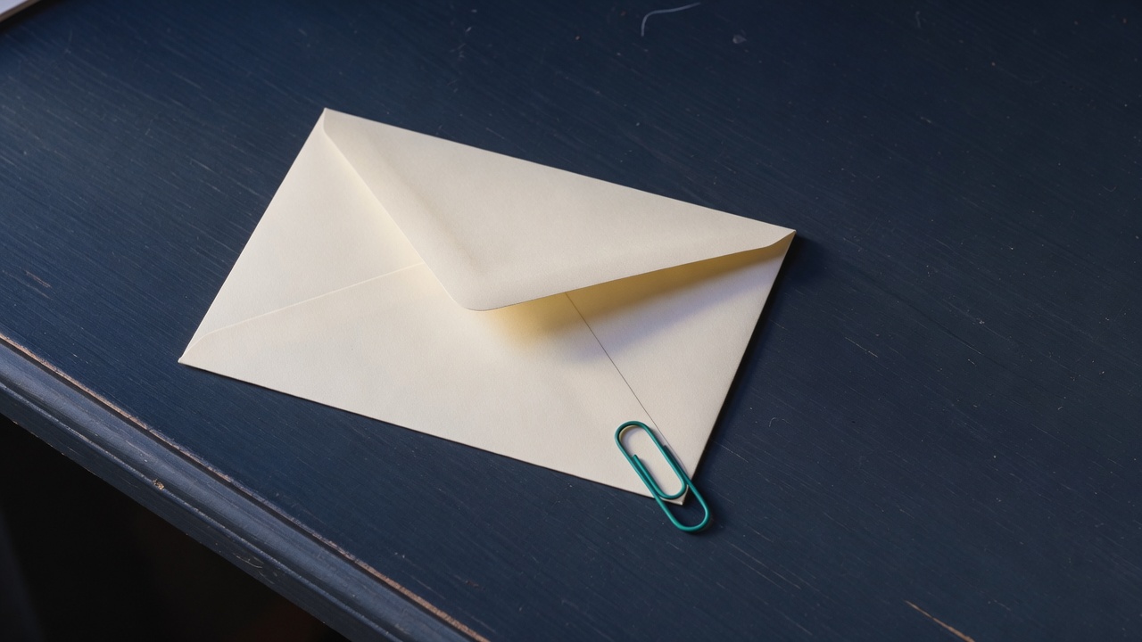 Cream stationery and a teal accent on a dark navy desk