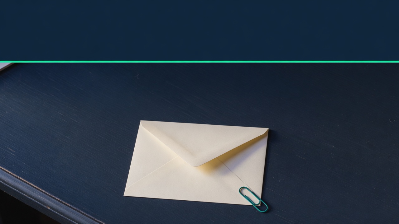 Cream stationery and a teal accent on a dark navy desk