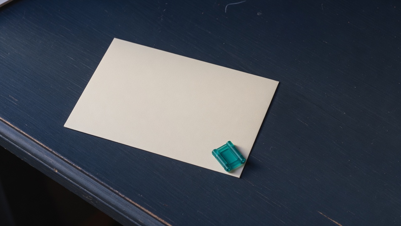 Cream stationery and a teal accent on a dark navy desk
