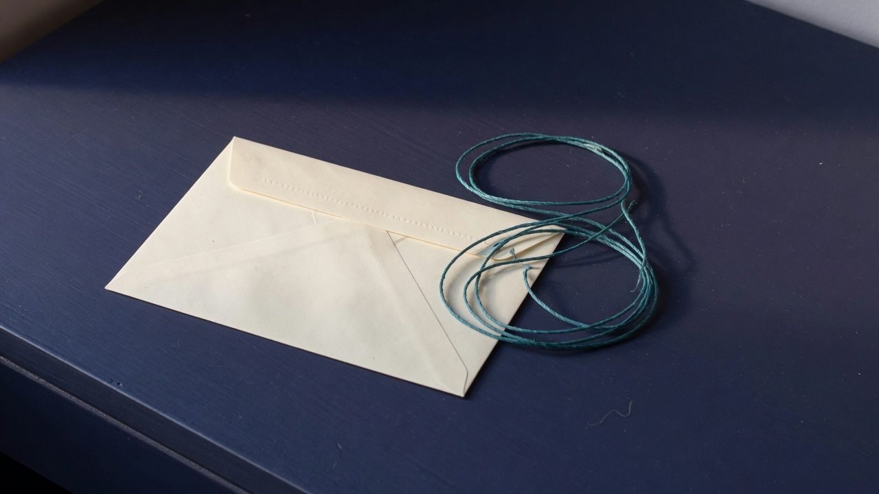 Cream stationery and a teal accent on a dark navy desk